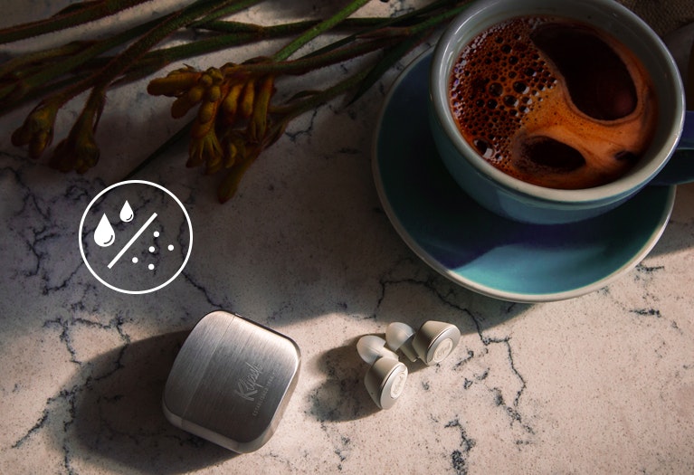 T5 II True Wireless earphones next to coffee Mobile
